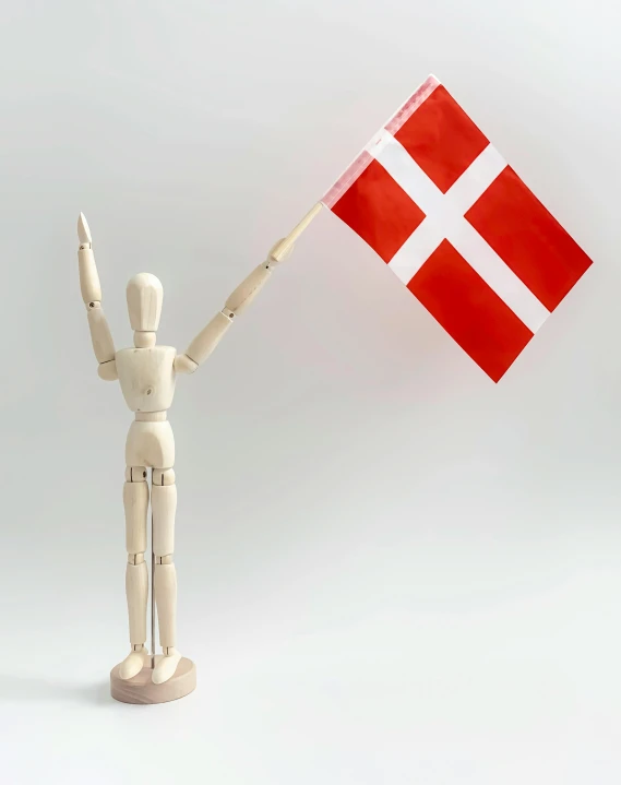 a wooden mannequin holding a danish flag, happening, triumphant pose, instagram post, profile image, complete figure