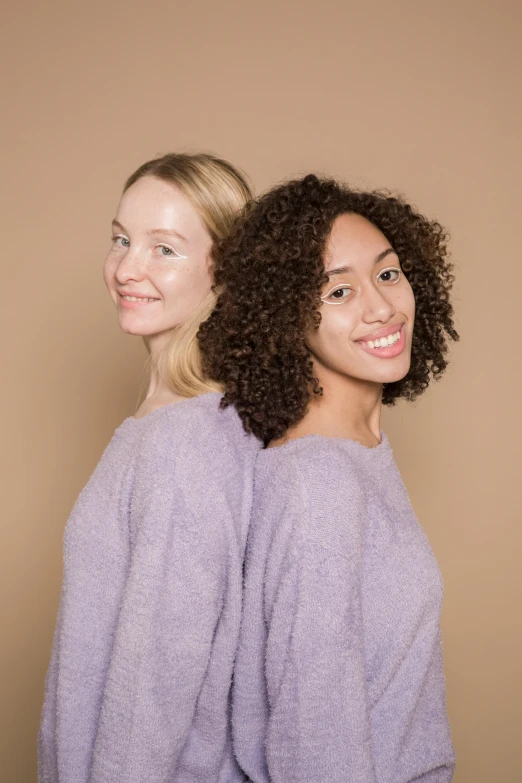 a couple of women standing next to each other, trending on pexels, renaissance, purple skin color, one blonde and one brunette, wavy hair spread out, symmetrical image