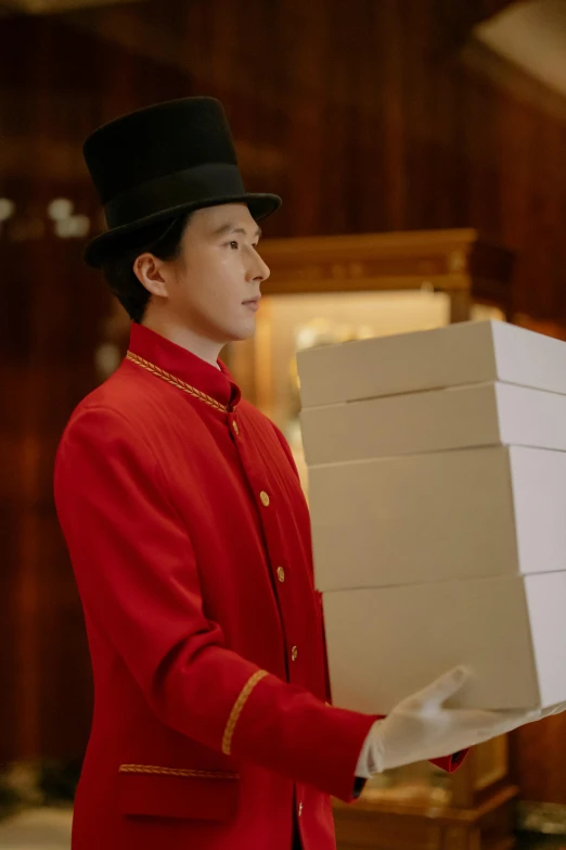 a man in a red uniform holding a box of pizza, inspired by Wang Meng, happening, in their noble mansion, netflix, wearing top hat, premium quality