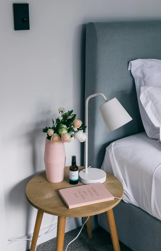 a bed room with a neatly made bed, a still life, inspired by Constantin Hansen, featured on pinterest, skincare, books and flowers, emerging from her lamp, full product shot