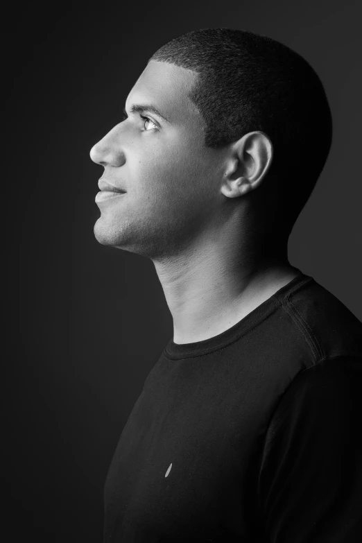 a black and white photo of a man, inspired by Nadim Karam, drake the rapper's face, looking to the right, michael page, brazilian ronaldo