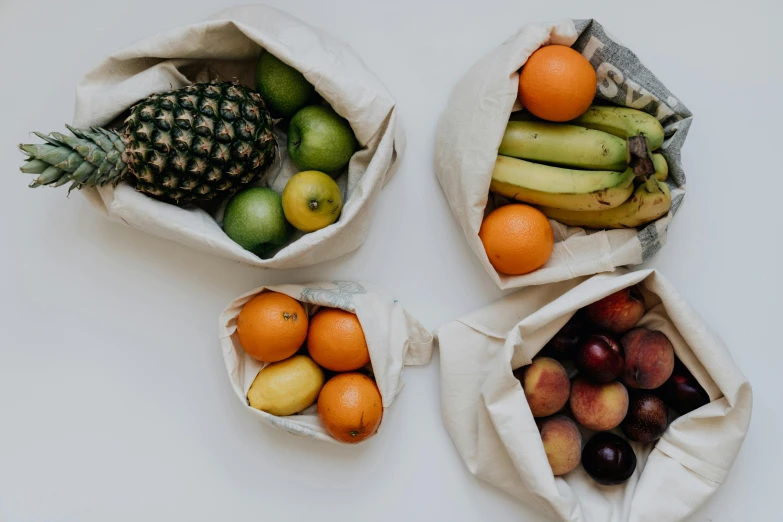 three bags filled with different types of fruit, unsplash, fan favorite, cloth wraps, set photo, ayne haag