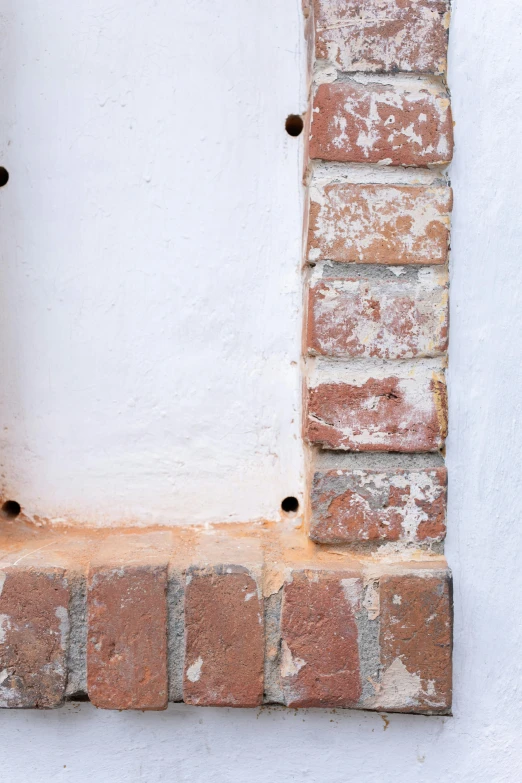 a red fire hydrant sitting on top of a brick wall, inspired by Rachel Whiteread, unsplash, detail, metal framed portal, white with chocolate brown spots, castle wall