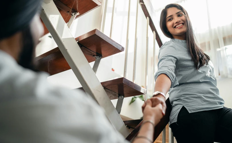 a woman shaking hands with a man on the stairs, pexels contest winner, a still of a happy, professional render, alana fletcher, fully functional