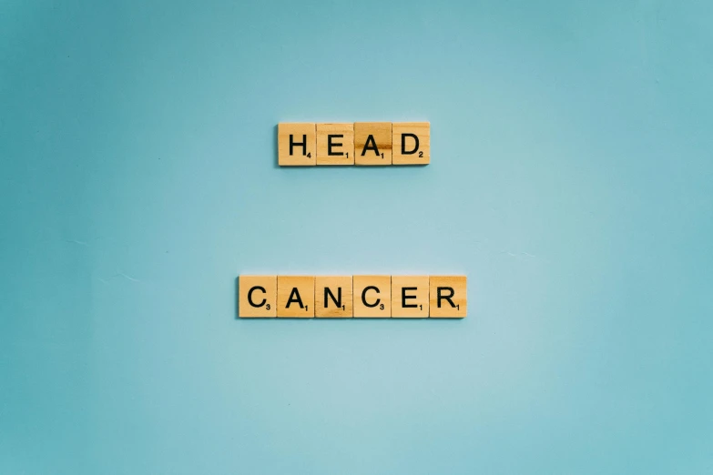 the word head cancer spelled with scrabbles on a blue background, an album cover, pexels contest winner, high forehead, high resolution print :1 cmyk :1, shot on canon eos r5, green head