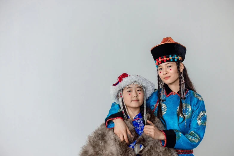 a couple of people standing next to each other, a portrait, inspired by Mei Qing, trending on unsplash, hurufiyya, russian costume, kids, in front of white back drop, inuk