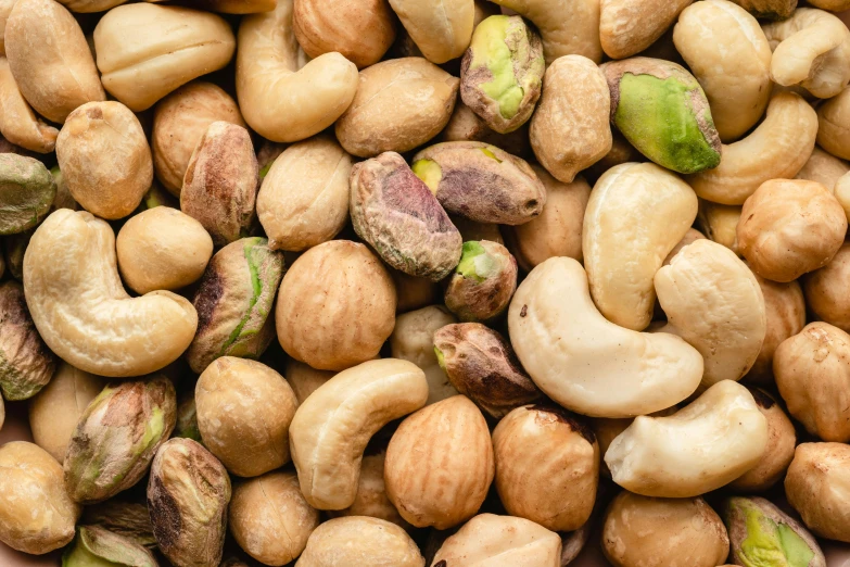 a pile of nuts sitting on top of each other, an album cover, trending on pexels, renaissance, background image, middle eastern, close-up product photo, multicoloured