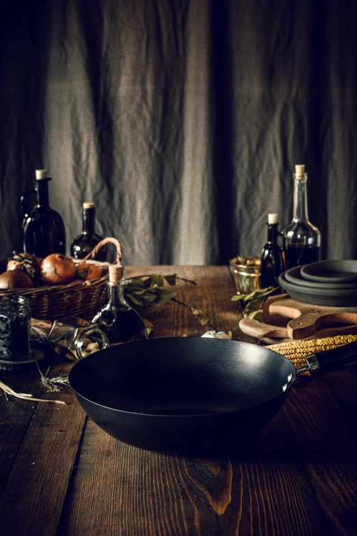 a black frying pan sitting on top of a wooden table, a still life, by Andries Stock, pexels contest winner, renaissance, vases and bottles, food commercial 4 k, square, fantasy medium shot