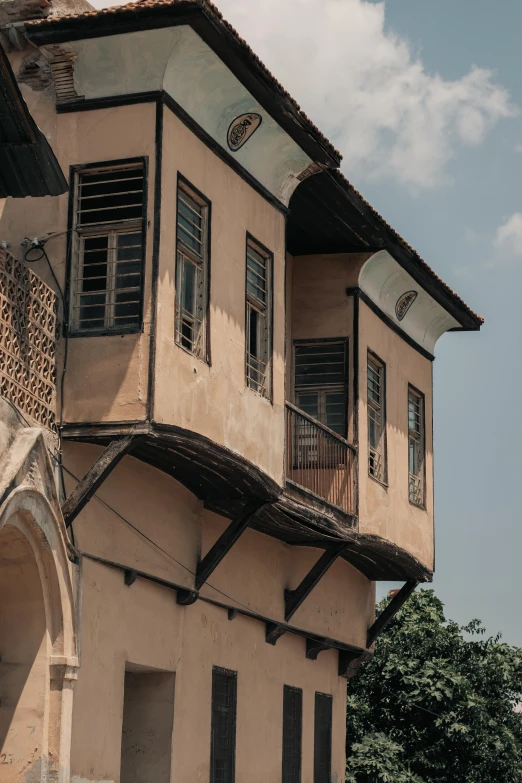 a motorcycle is parked in front of a building, pexels contest winner, renaissance, sri lanka, view from below, medieval house, balconies