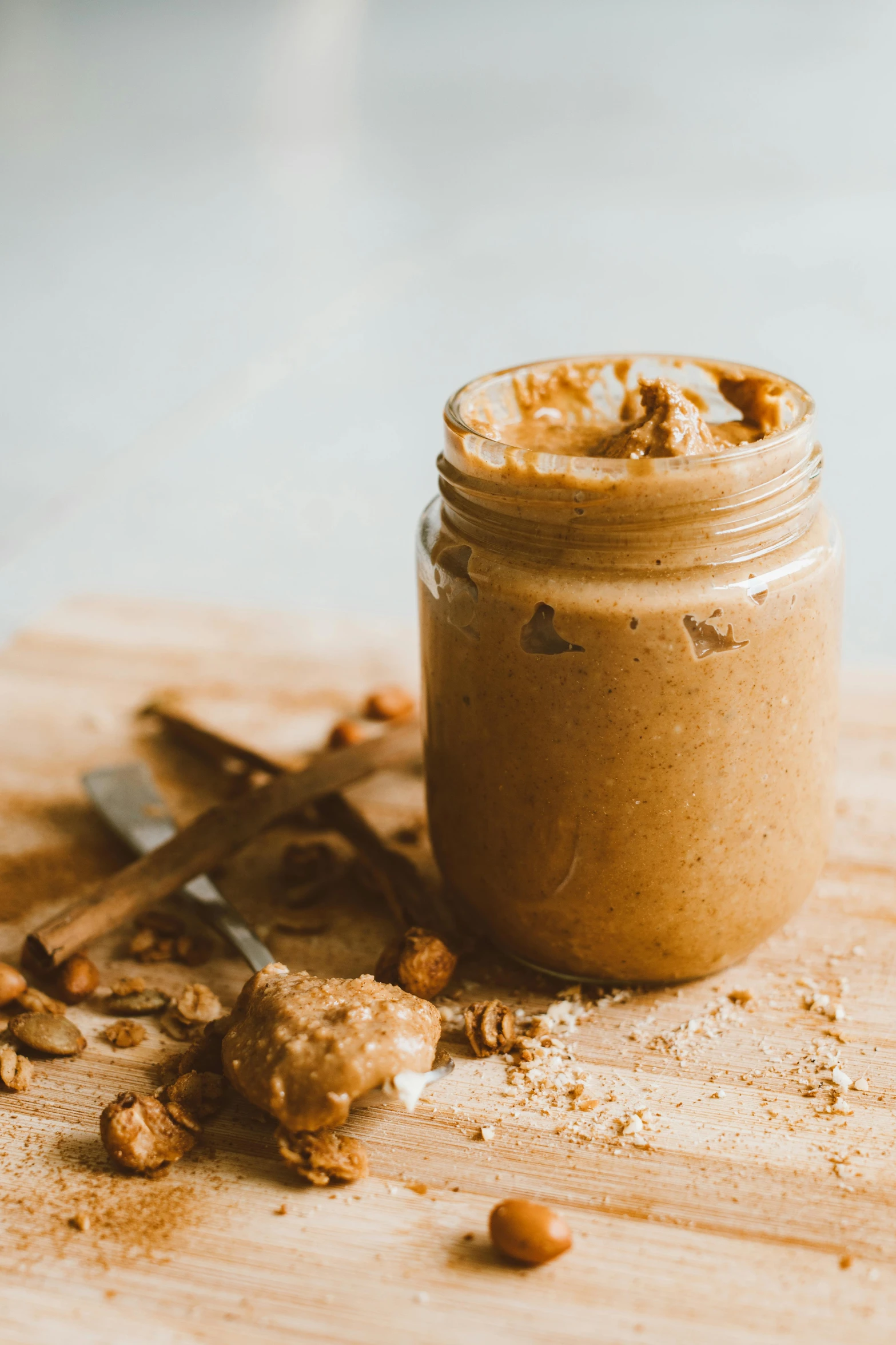 a jar of peanut butter on a cutting board, unsplash, detailed product image, bronze, cinnamon, manuka