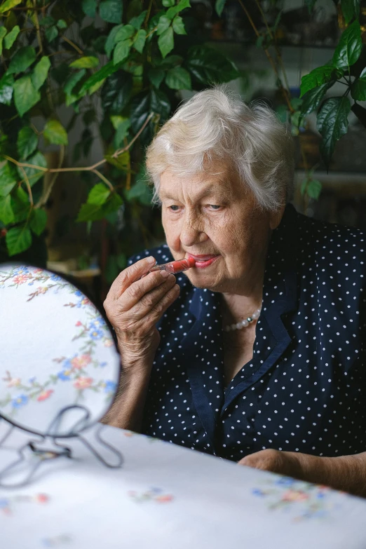 a woman sitting at a table eating a piece of cake, pexels contest winner, photorealism, elder, putting on lipgloss, thoughtful ), with an ashtray on top