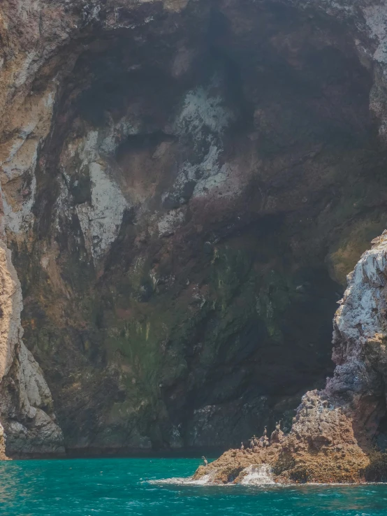 a couple of people riding on the back of a boat, an album cover, pexels contest winner, romanticism, natural cave wall, zoomed in, /r/earthporn, panorama