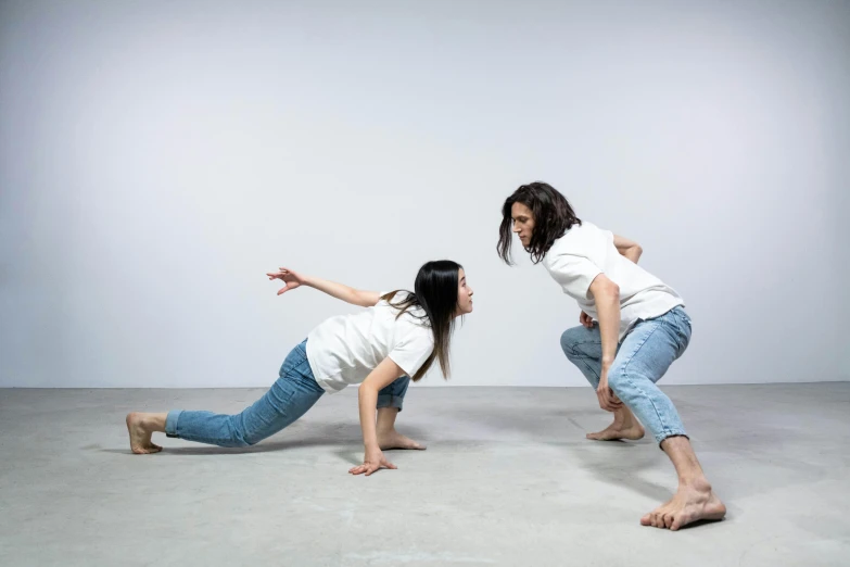 a couple of women standing next to each other on a cement floor, inspired by Fei Danxu, crawling on the ground, dressed in a white t shirt, performance, profile image