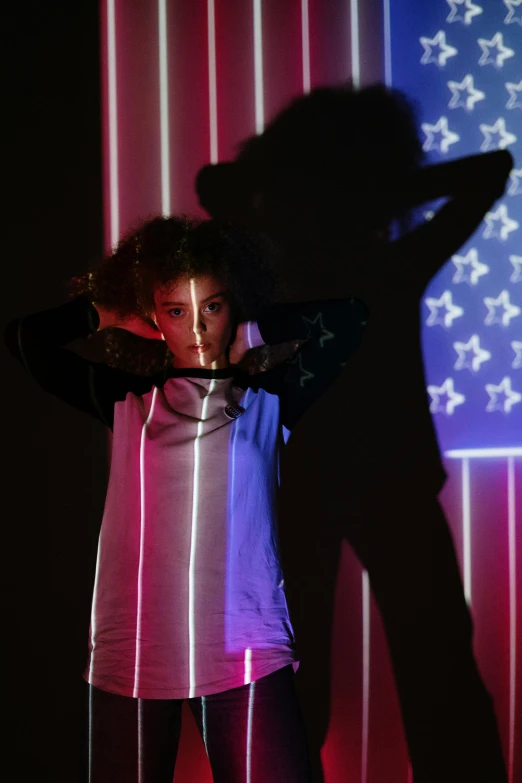 a woman standing in front of an american flag, holography, little kid, futuristic fashion show, promo photo, teenage