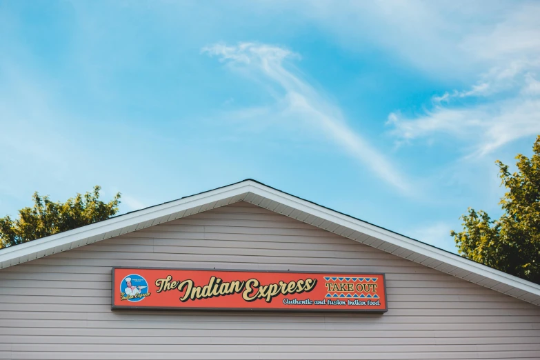 a sign that is on the side of a building, indian empress, restaurant exterior photography, the milky way express, fan favorite