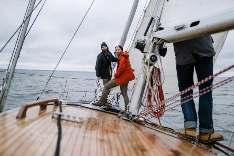 a couple of people standing on top of a boat, pexels contest winner, happening, he's on an old sailing boat, greta thunberg, windy weather, thumbnail