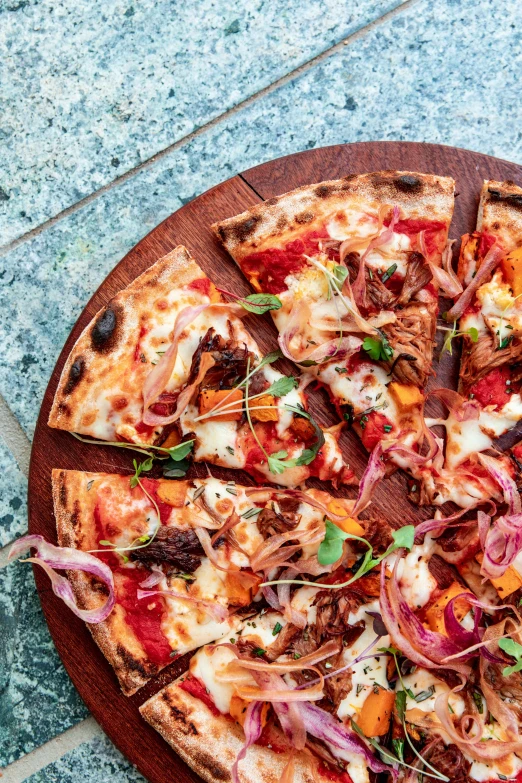 a pizza sitting on top of a wooden cutting board, inspired by Richmond Barthé, rich colourful, braavos, daily specials, 2 5 yo