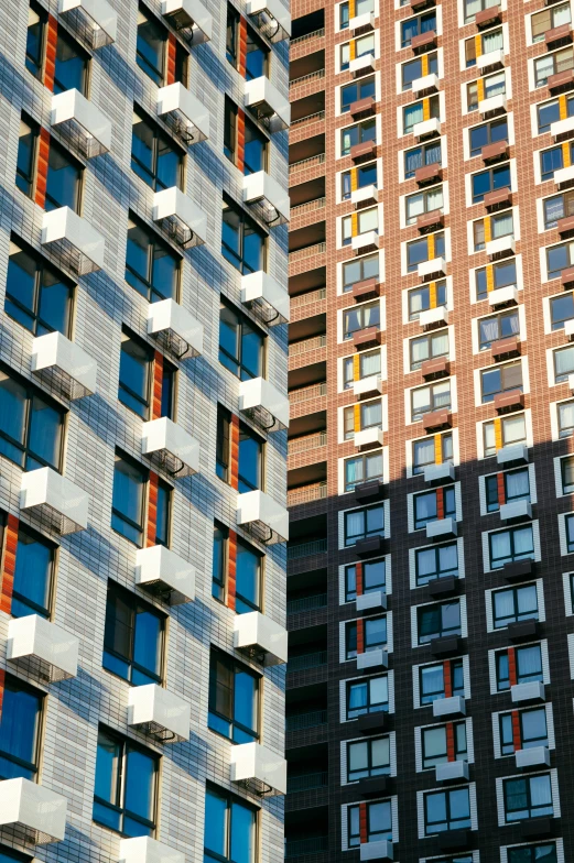 a couple of tall buildings next to each other, inspired by John Haberle, unsplash, modernism, harlem, panels, 2000s photo, telephoto shot