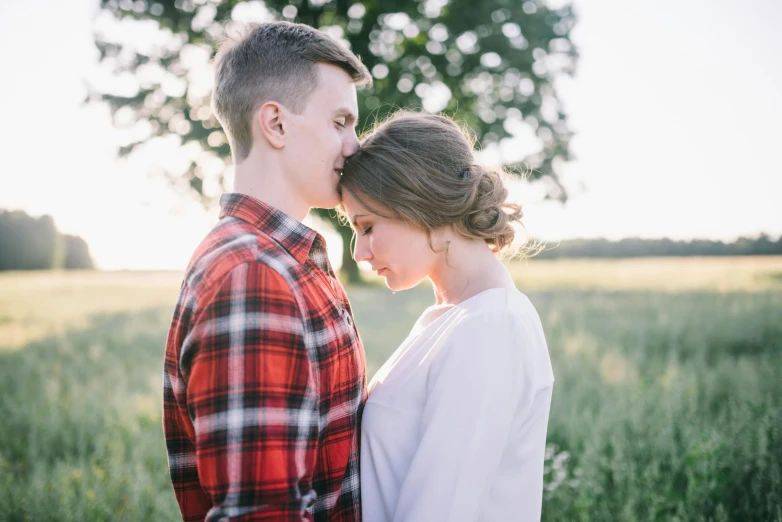 a man and woman standing next to each other in a field, pexels contest winner, profile image, boy girl traditional romance, high forehead, date