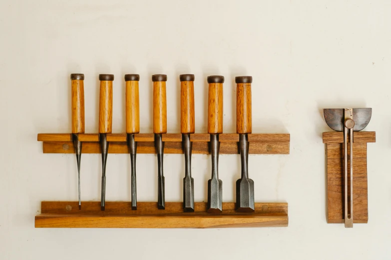 a bunch of tools that are on a shelf, inspired by Afewerk Tekle, unsplash, folk art, lined up horizontally, mills, group of seven, late 1 9 6 0's