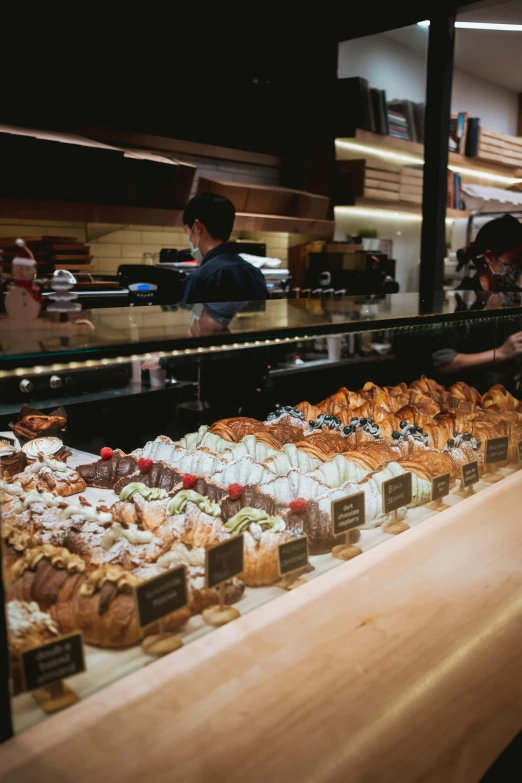 a bakery filled with lots of different types of pastries, by Robbie Trevino, trending on unsplash, koji morimoto shinjuku, 3/4 side view, aussie baristas, made of glazed