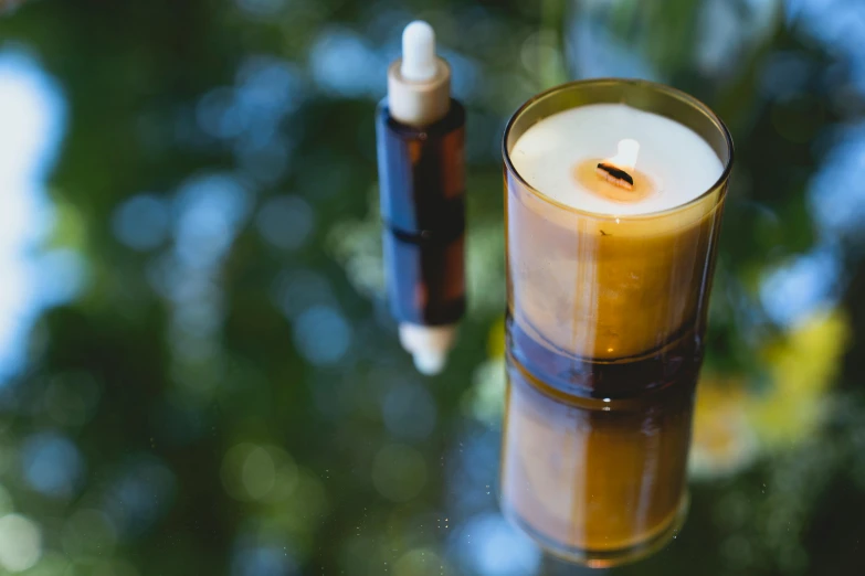 a candle sitting on top of a glass table, manuka, oils, detailed product image, fan favorite