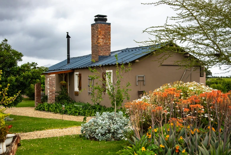 a house sitting on top of a lush green field, by Hubert van Ravesteyn, unsplash, renaissance, woodfired, in a cottagecore flower garden, exterior view, brown