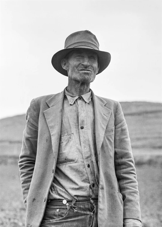 a black and white photo of a man in a hat, a black and white photo, by Dorothea Lange, ancient irish, dressed in a worn, sid mead, australian