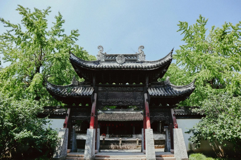a pagoda sitting in the middle of a lush green park, inspired by Wu Daozi, pexels contest winner, large gate, roof with vegetation, grey, baotou china
