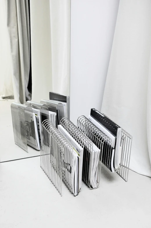 a mirror sitting on top of a white table, an album cover, computer art, stacked computer screens, coated pleats, computer equipment, silver，ivory