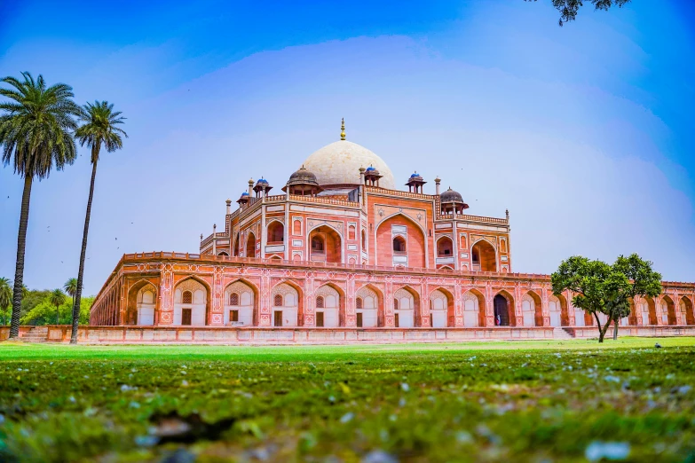 a large building sitting on top of a lush green field, a colorized photo, pexels contest winner, renaissance, beautiful futuristic new delhi, tomb, arabic architecture, white sweeping arches