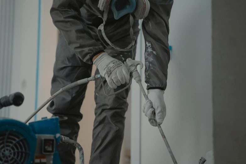 a man using a power washer to clean a room, a detailed painting, pexels contest winner, grey and blue theme, construction, worksafe. cinematic, laquer and steel