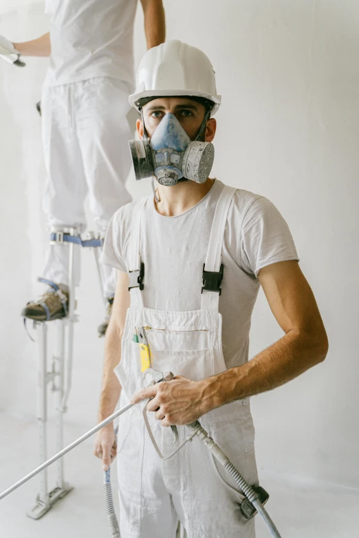 a couple of men standing on top of a white wall, a hyperrealistic painting, pexels contest winner, arbeitsrat für kunst, dust mask, wearing plumber uniform, with a white muzzle, looking serious