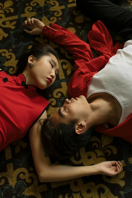 a couple of people laying on top of a carpet, an album cover, inspired by Fei Danxu, romanticism, wearing red attire, still shot from movie, bao pnan, lesbians