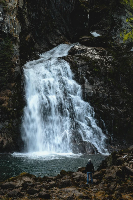 a person standing in front of a waterfall, new hampshire, unsplash 4k, multiple stories, full frame image