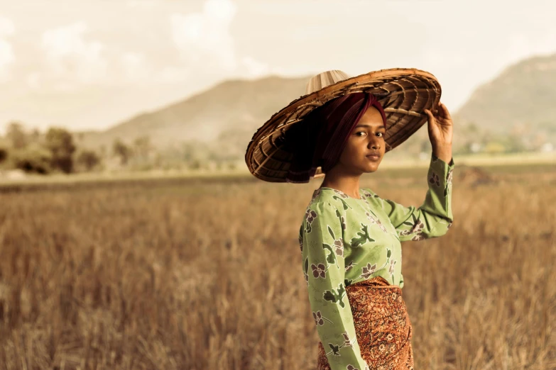 a woman standing in a field with a hat on her head, pexels contest winner, sumatraism, square, google arts and cultures, avatar image, indian girl with brown skin