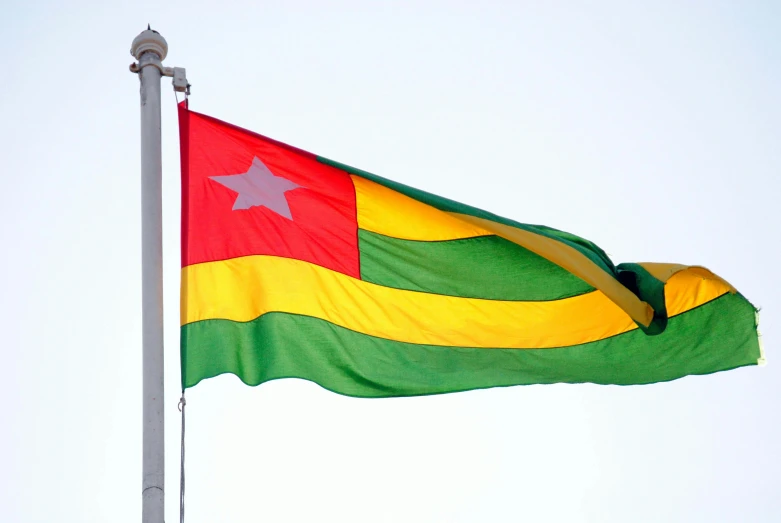 the flag of togo flies high in the sky, an album cover, inspired by Géza Dósa, pexels, hurufiyya, square, in 2 0 1 2, cga, banana