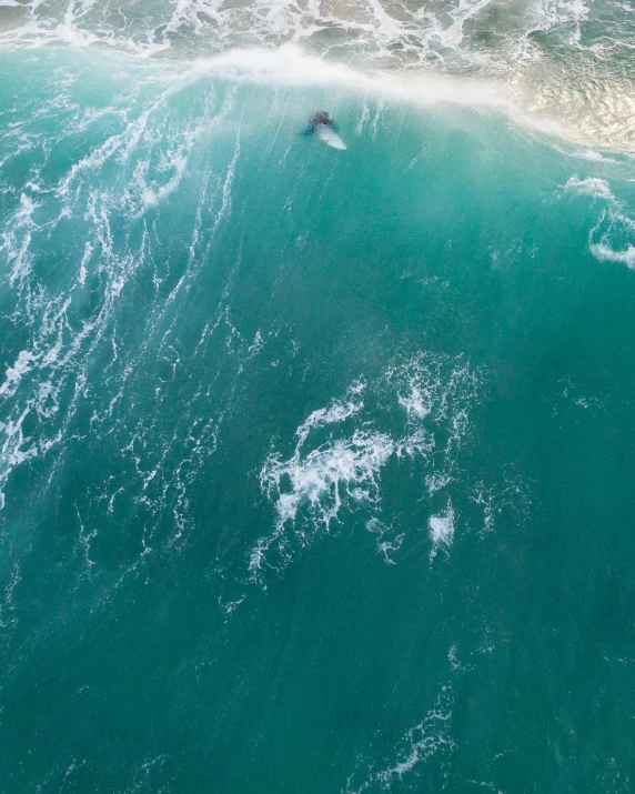a man riding a wave on top of a surfboard, pexels contest winner, hurufiyya, from 1 0 0 0 feet in distance, thumbnail, south african coast, an eerie whirlpool