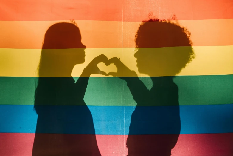 two people making a heart shape with their hands, a cartoon, by Julia Pishtar, pexels, lgbt flag, dark skinned, profile image, historical photo