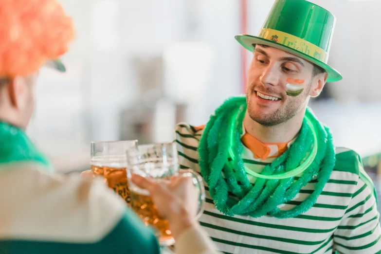 a man in a green hat holding a glass of beer, pexels contest winner, striped, fancy dress, ad image, clover