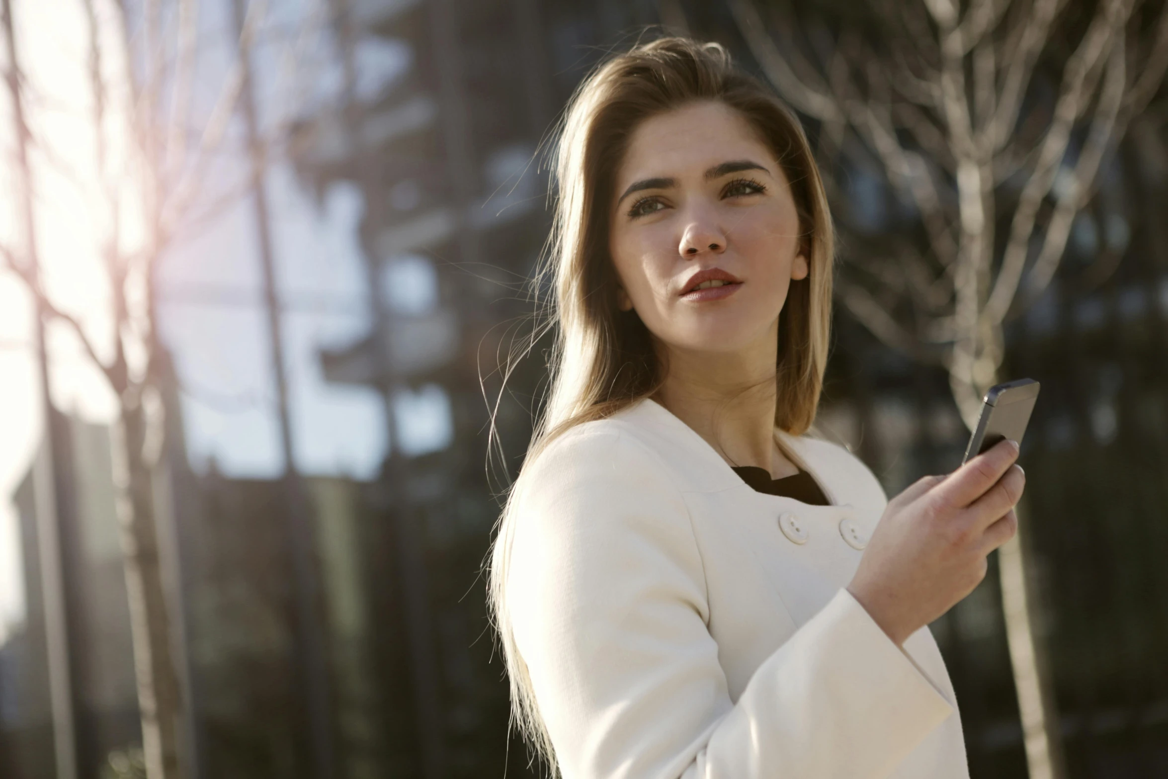 a woman is looking at her cell phone, a portrait, pexels contest winner, girl in suit, sunlit, attractive brown hair woman, cinematic shot ar 9:16 -n 6 -g