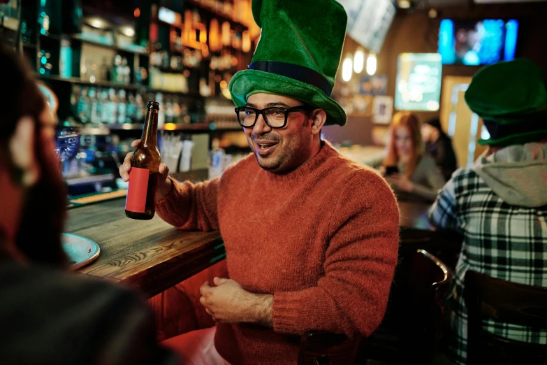 a man in a green hat sitting at a bar, pexels contest winner, fancy dress, irish genes, thumbnail, celebrating