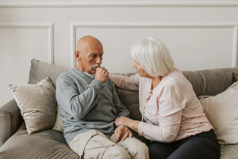 a man and a woman sitting on a couch, pexels contest winner, photorealism, nursing home, touching heads, looking from side, colour photograph