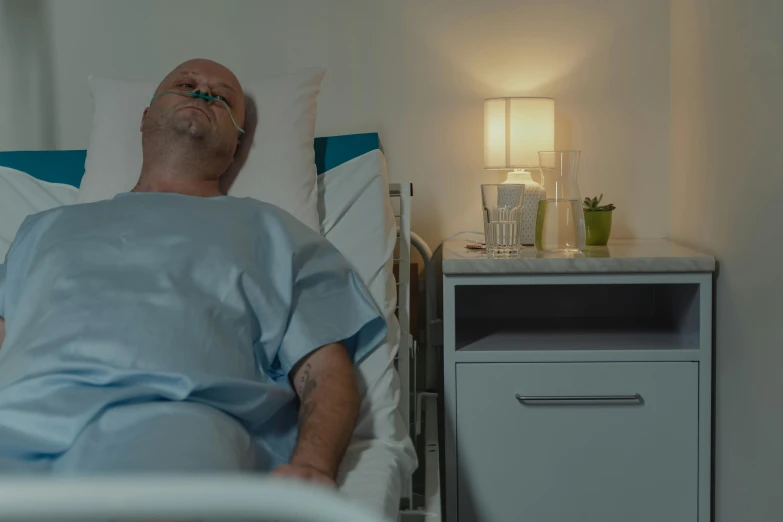 a man laying in a hospital bed next to a night stand, a photo, ultra realistic 8k octan photo, profile image, colour corrected, worksafe. cinematic