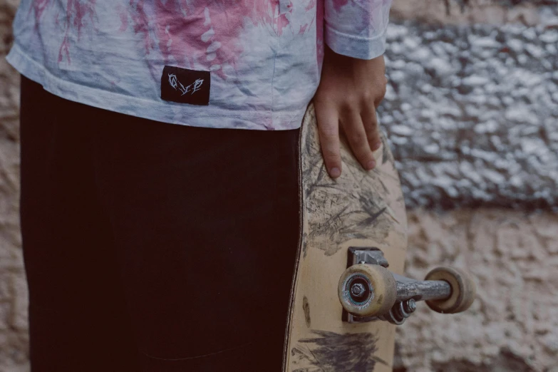 a close up of a person holding a skateboard, inspired by Lucas Vorsterman, wings lace wear, split dye, vred, chalked