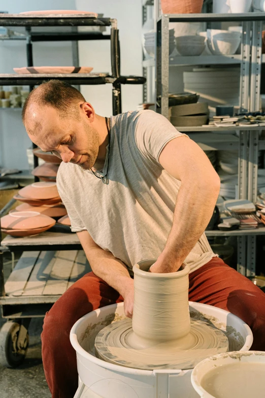 a man is making a pot out of clay, a portrait, instagram, arbeitsrat für kunst, large tall, production photo, thumbnail