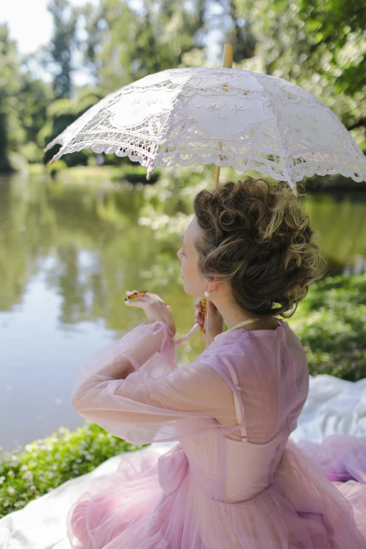 a woman in a pink dress holding an umbrella, inspired by Konstantin Somov, unsplash, rococo, near pond, elaborate hair worn up, slide show, victorian lace