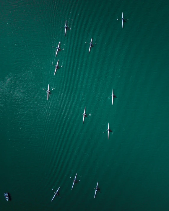 a number of boats in a body of water, by Jacob Toorenvliet, pexels contest winner, small elongated planes, hq 4k phone wallpaper, sup, teal aesthetic