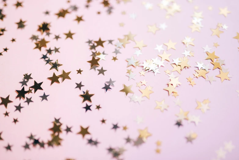 a bunch of gold and silver stars on a pink background, by Julia Pishtar, trending on unsplash, confetti, star charts, empty background, multiple stories