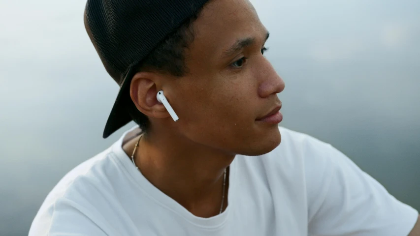 a man with a cell phone in his ear, trending on pexels, airpods, square, detailed product image, “hyper realistic
